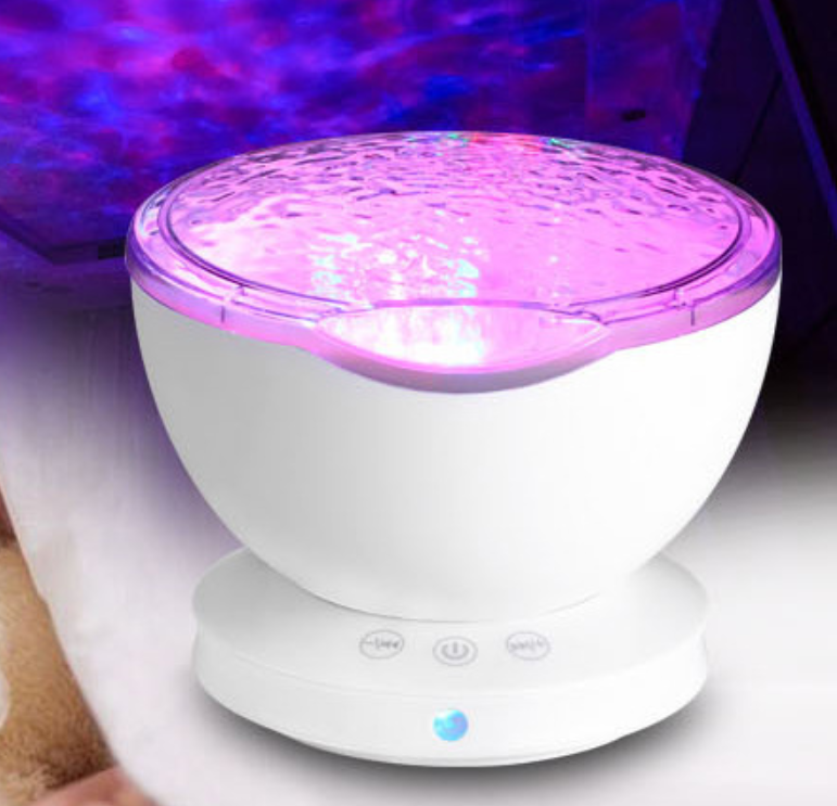 Colorful LED night light on a white surface with a blurred background