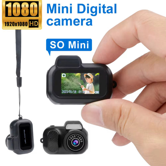 Small digital camera held by a hand with text indicating HD resolution and mini size.