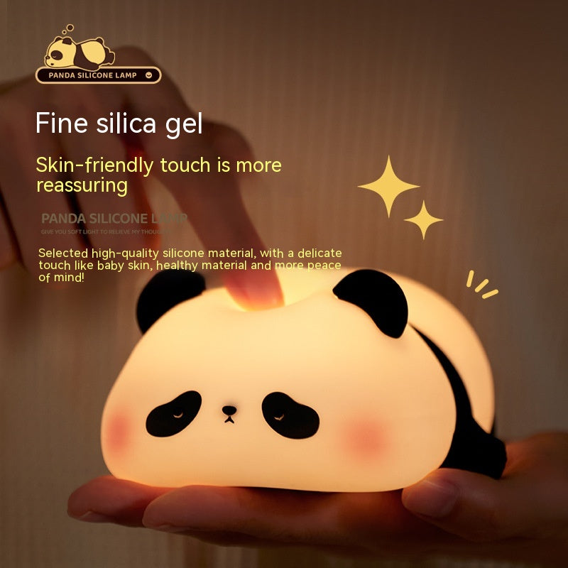 Panda silicone lamp held in a hand with a warm glow, featuring text about fine silica gel and skin-friendly touch.